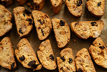 Homemade italian cantuccini biscotti cookies with hazelnuts and dried cranberries on baking paper