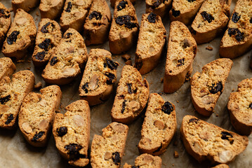 Homemade italian cantuccini biscotti cookies with hazelnuts and dried cranberries on baking paper
