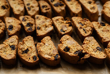 Homemade italian cantuccini biscotti cookies with hazelnuts and dried cranberries on baking paper
