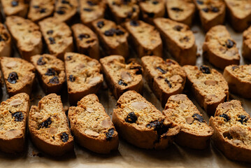 Homemade italian cantuccini biscotti cookies with hazelnuts and dried cranberries on baking paper
