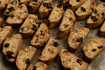 Homemade italian cantuccini biscotti cookies with hazelnuts and dried cranberries on baking paper