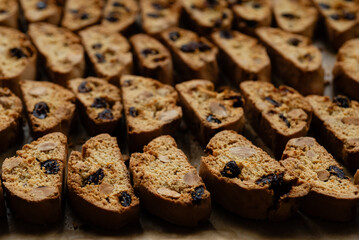 Homemade italian cantuccini biscotti cookies with hazelnuts and dried cranberries on baking paper