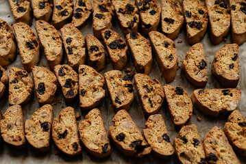 Homemade italian cantuccini biscotti cookies with hazelnuts and dried cranberries on baking paper