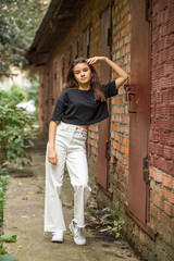 Full body portrait of a young beautiful brunette girl, outdoors