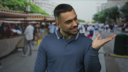 Fototapeta premium Young man hand showing three fingers at busy street market stall amid city scene; playful confidence.