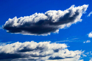 A vibrant blue sky streaked with dynamic clouds
