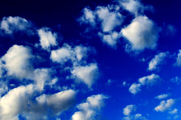 A vibrant blue sky streaked with dynamic clouds