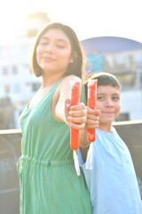 Happy latin siblings holding fruit ice.