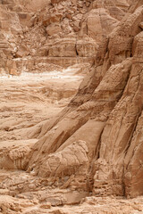 Layered sandstone cliff in White Canyon, Wadi Qunai, Sinai Peninsula, Egypt. Eroded rock formations shaped by wind and time in an arid desert environment.