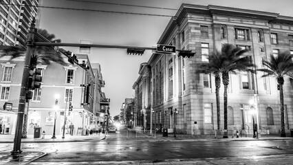 Urban streetscape of New Orleans showing buildings lit up during nighttime city scene