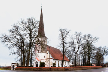 Historic Nurme Lutheran Church building with stone wall in Latvia