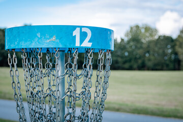 blue discgolf basket on hole number 12