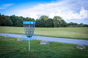 blue discgolf basket on hole number 12
