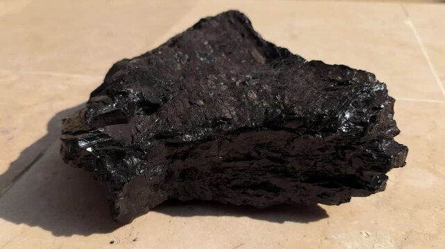 Piece of Anthracite Coal in 4K. High-Grade Hard Coal with Shiny Carbon Surface and Sharp Texture, Representing the Highest Rank of Coal Captured in Cinematic High-Detail Industrial, Geological Footage