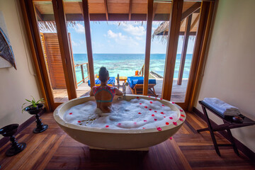 A female tourist in the hot tube. Tropical island beach landscape exotic shore coast. Tranquil closeup calm sea water waves. Summer vacation, holiday amazing nature. Relax paradise, Maldives.
