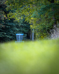 blue discgolf basket in the park