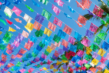 Papel Picado banners hang in the sky during local celebrations.  Todos Santos, Baja Sur, Mexico.