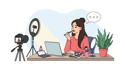 Professional beauty vlogger applying lipstick while recording a makeup tutorial video at her desk with camera, ring light, and laptop.