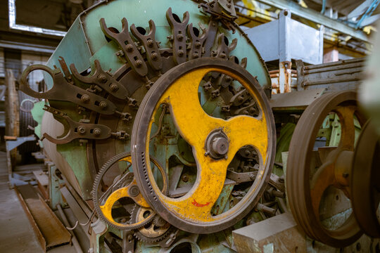 Yellow flywheel on industrial machinery detail