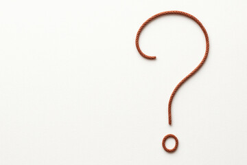 Fototapeta premium A question mark made of rope as a symbol of doubt and choice. Space for text.