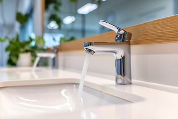 Modern bathroom faucet with running water