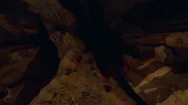 Circular Look Around Inside Dim Cave Showing Tall Rough Rock Walls in Deep Shadowy View Creating Mysterious Underground Exploration Moment