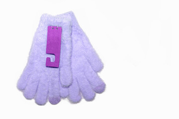 Fluffy children gloves in pastel colors on white background.