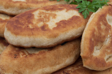 Traditional home baked fried potato pies with crispy crust and soft potato filling, classic домашняя выпечка served on plate, isolated on white background.