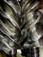 Hydraulic pump engine unit industrial repair metal machinery component with oil leakage on a workshop table for technical maintenance and mechanical engineering service center context