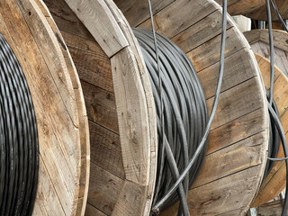 Industrial cable spool wooden reel electrical wire infrastructure for power distribution telecommunications construction site and utility network installation projects