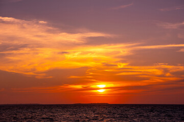 Obraz premium Beautiful sunset. Tranquil closeup calm sea water waves with palm trees. Tropical island beach landscape exotic shore coast. Summer vacation, holiday amazing nature, Maldives.