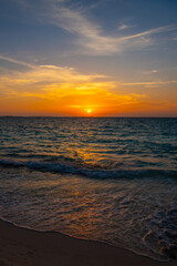 Obraz premium Beautiful sunset. Tranquil closeup calm sea water waves with palm trees. Tropical island beach landscape exotic shore coast. Summer vacation, holiday amazing nature, Maldives.