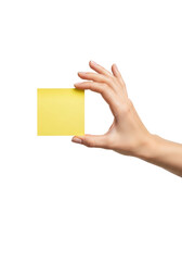 Obraz premium Close-up of a young caucasian woman's hand with clear polish gently pinching a blank yellow sticky note, isolated against a seamless high-key white background. Concept of memory, communication, and