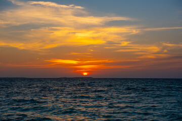 Obraz premium Beautiful sunset. Tranquil closeup calm sea water waves with palm trees. Tropical island beach landscape exotic shore coast. Summer vacation, holiday amazing nature, Maldives.