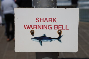 Sign indicating the shark warning bell