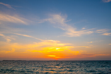 Obraz premium Beautiful sunset. Tranquil closeup calm sea water waves with palm trees. Tropical island beach landscape exotic shore coast. Summer vacation, holiday amazing nature, Maldives.