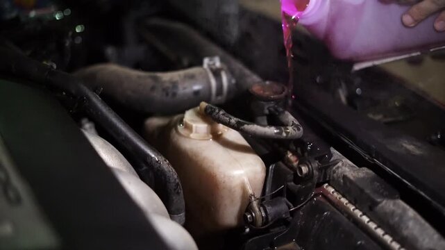 Adding cooling oil to an overheated car engine