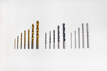 Different types of drill bits for wood, metal and masonry isolated on white background