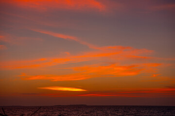 Fototapeta premium Beautiful sunset. Tranquil closeup calm sea water waves with palm trees. Tropical island beach landscape exotic shore coast. Summer vacation, holiday amazing nature, Maldives.