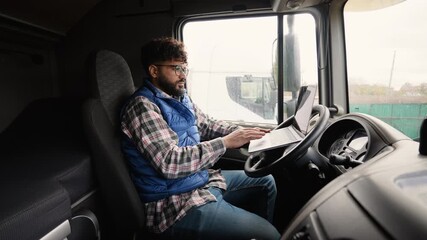 Truck driver using a laptop in the cabin for route planning