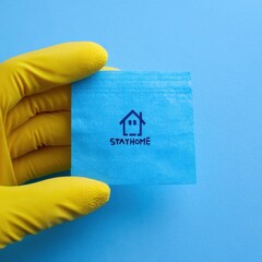 Guidance on Staying Home with Illness: Hand in Glove Indicating Cozy House, Emphasizing Health and Safety During Epidemics, Bright Blue Background with Space for Text
