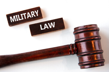 MILITARY LAW - words on wooden brown bars on a white background with a judge's gavel