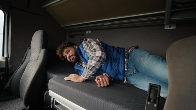 Truck driver waking up from a nightmare in a sleeper cab