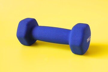 blue barbell on yellow background