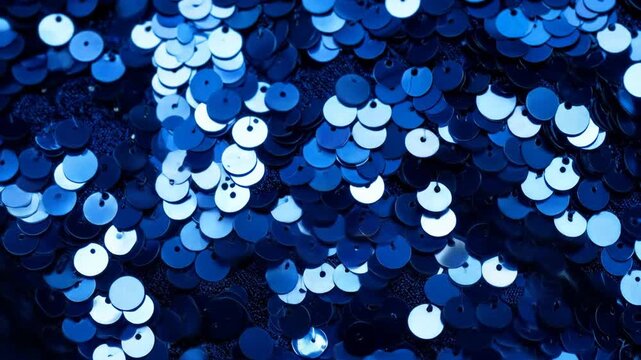 Close-up view of vibrant blue sequins creating a sparkling and festive background texture for design projects.