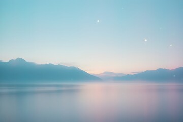 Obraz premium Pastel sunrise bathes the mountains and lake in soft light, creating a serene and peaceful scene