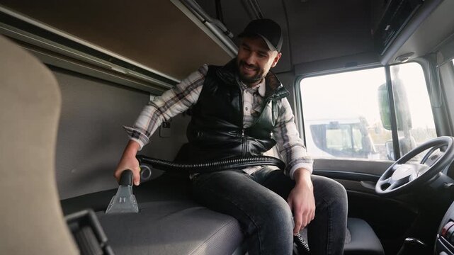 Truck driver cleaning sleeper cab upholstery