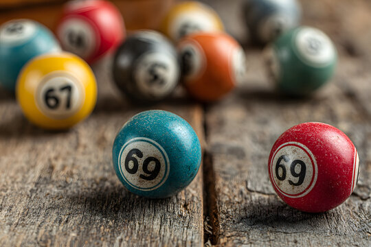 Bingo lotto on wooden background with copy space. Balls with bingo numbers. Flat lay.