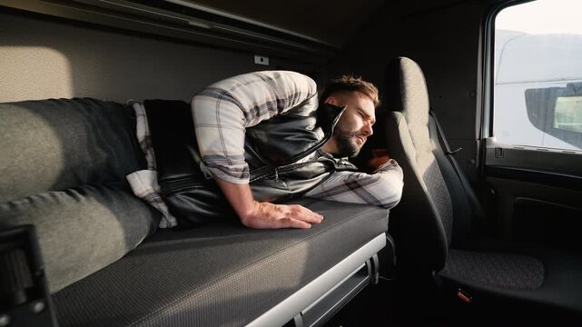 Tired truck driver waking up in his sleeper cab