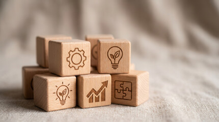 Fototapeta premium Wooden cubes featuring innovation development symbols arranged using controlled depth and minimal gently blurred backdrop